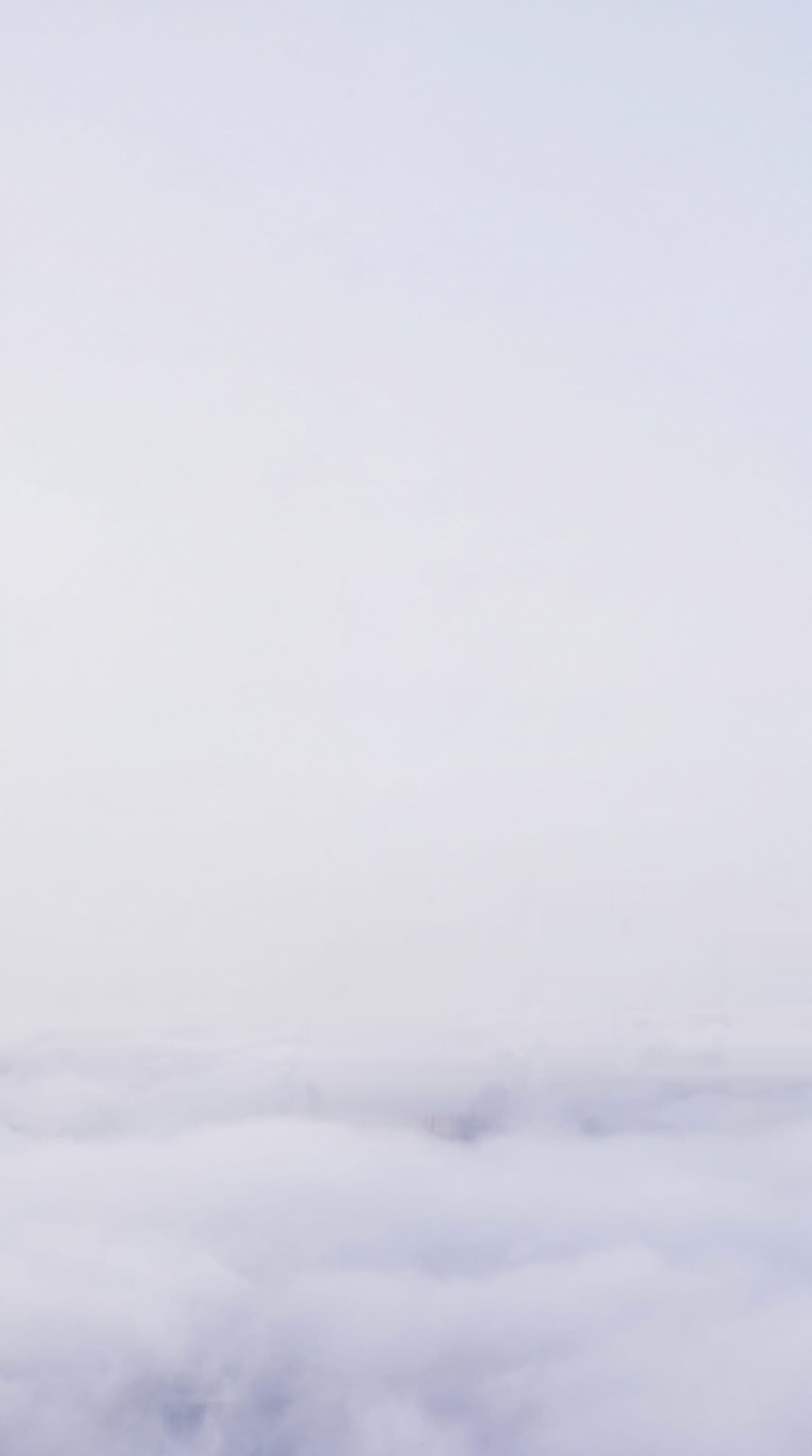 The tops of Warsaw's towers, with the Palace of Culture and Science, rising above a sea of clouds.